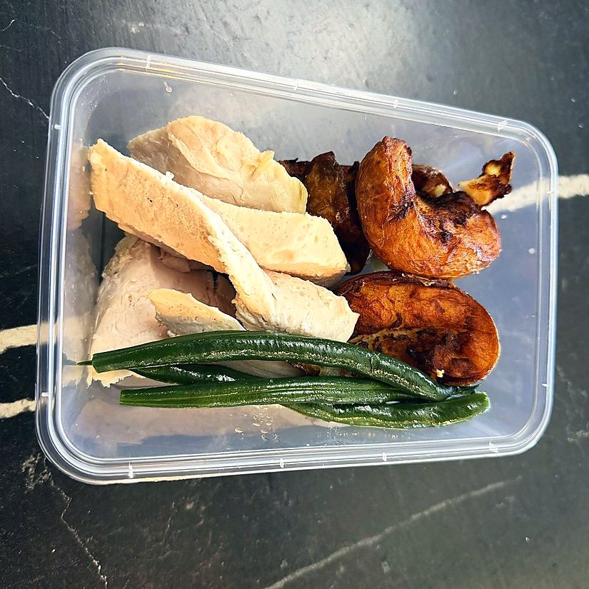 Crib lunch of roast chicken, potatoes and green beans, packed to go