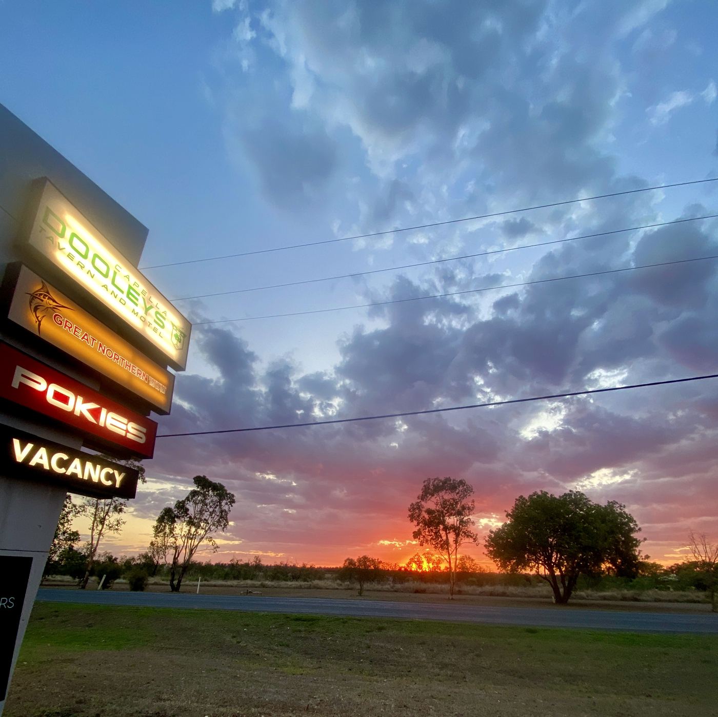 The Dooleys sign against a Central Highlands sunset
