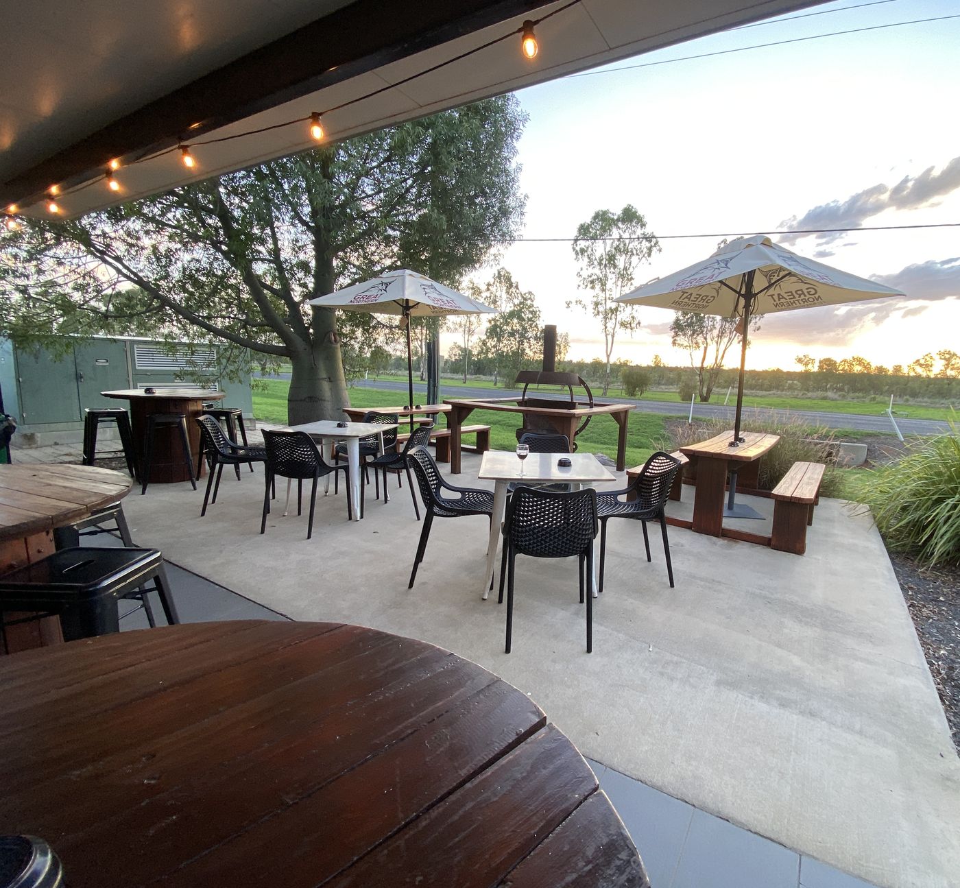 The beer garden and fire pit at sunset