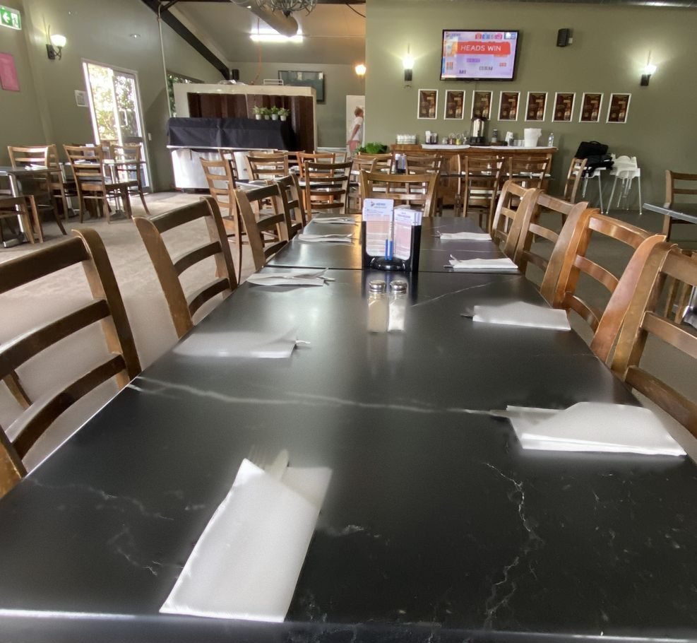 Marble-top tables set for dinner in the bistro