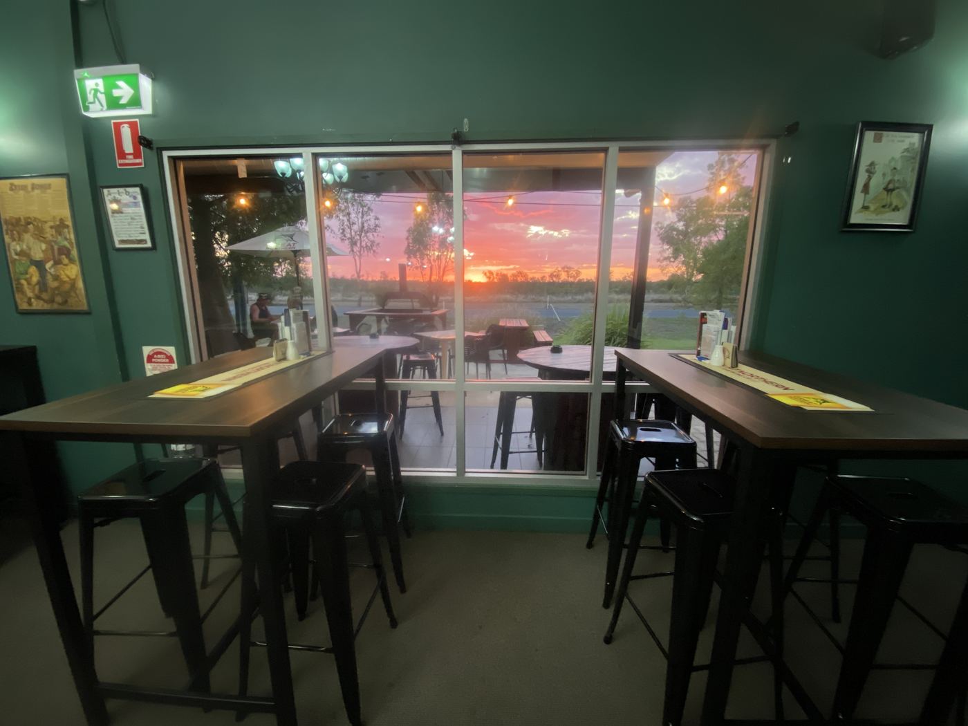 Bar tables in the Tavern with the sunset through the windows