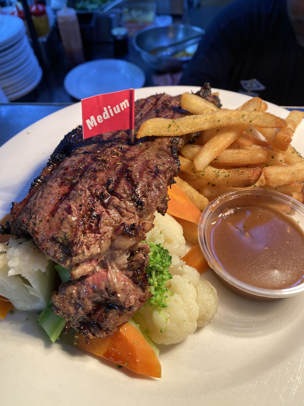 Char-grilled steak with chips and vegetables