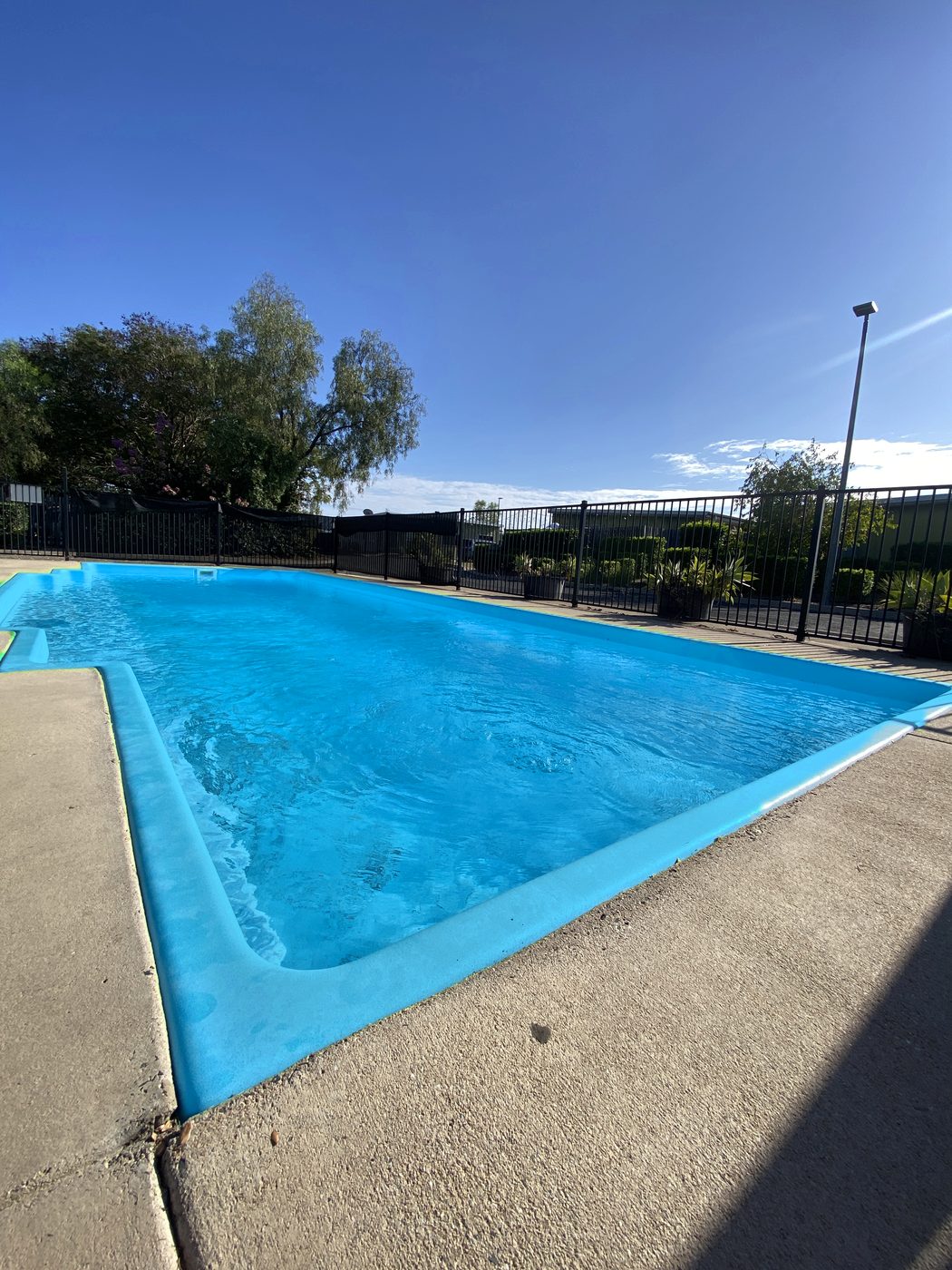 The guest pool at Dooleys Capella under a clear blue sky