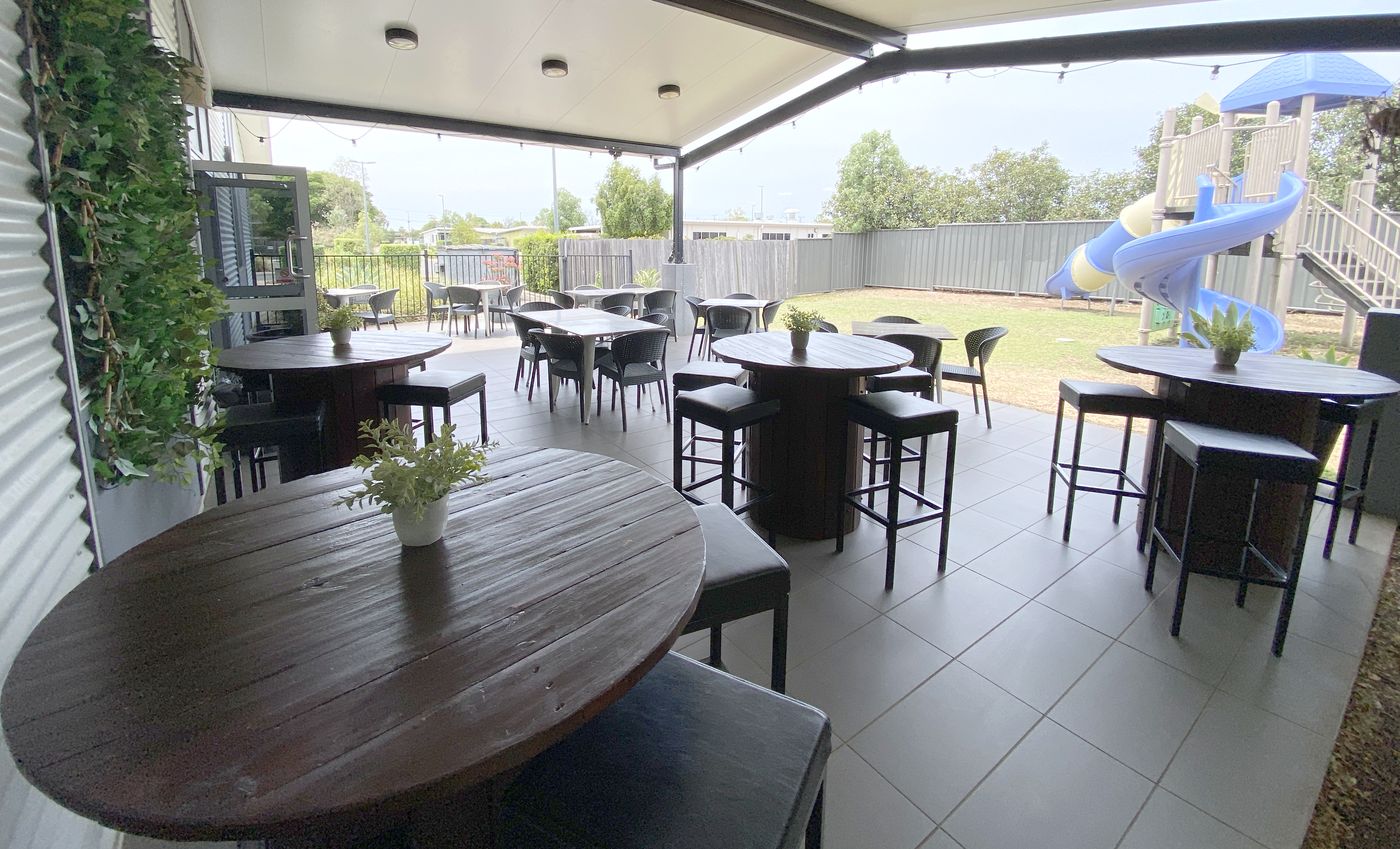 Alfresco tables beside the kids' slide